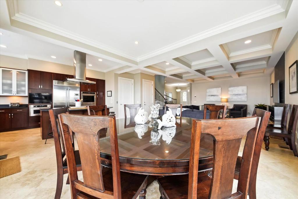 a dining room and kitchen with a table and chairs at 27 Singleton Beach- Oceanfront, Private Pool, Pool Table, FREE Activities Included in Hilton Head Island