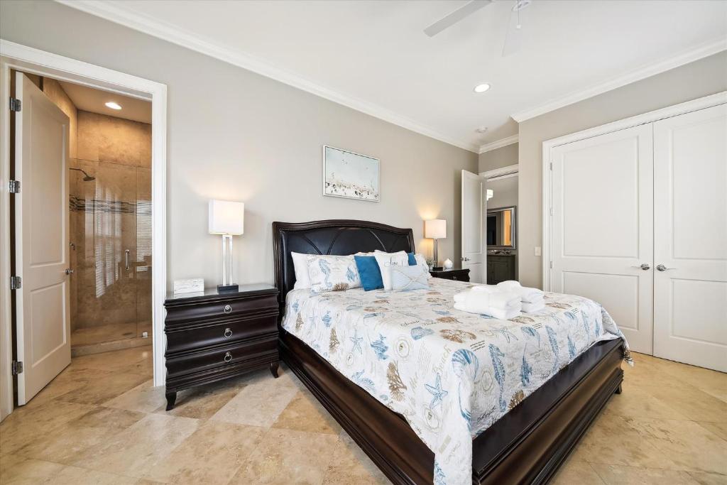a bedroom with a large bed and a walk in shower at 27 Singleton Beach- Oceanfront, Private Pool, Pool Table, FREE Activities Included in Hilton Head Island