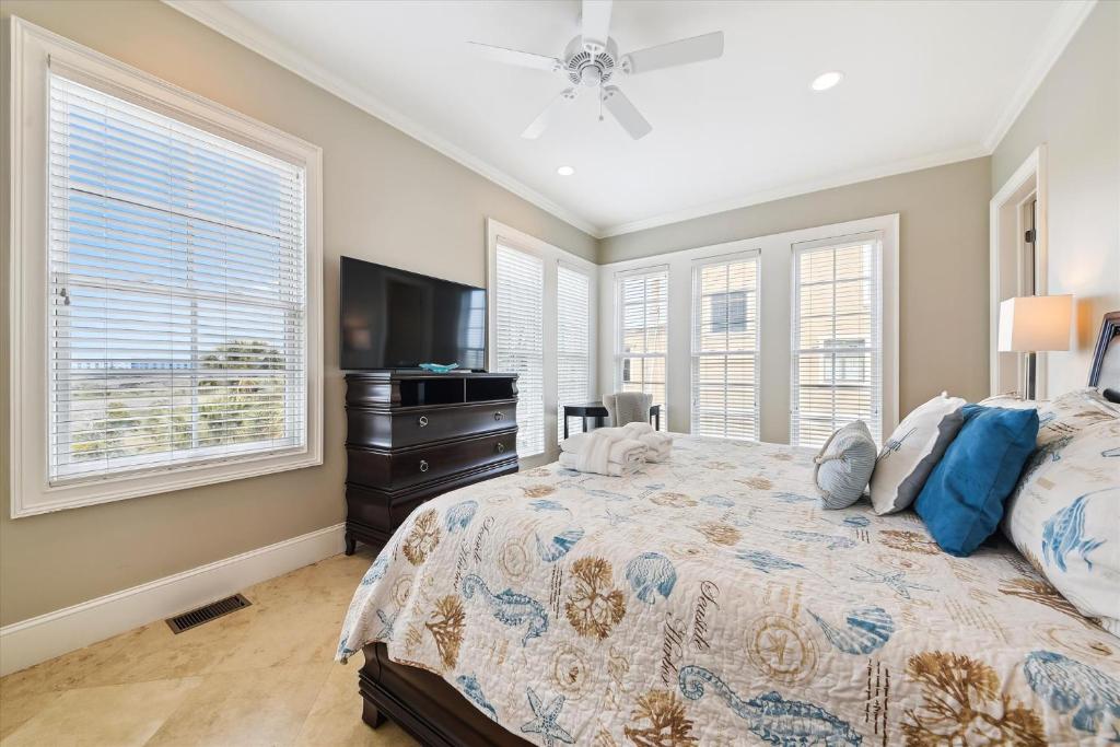 a bedroom with a bed and a flat screen tv at 27 Singleton Beach- Oceanfront, Private Pool, Pool Table, FREE Activities Included in Hilton Head Island