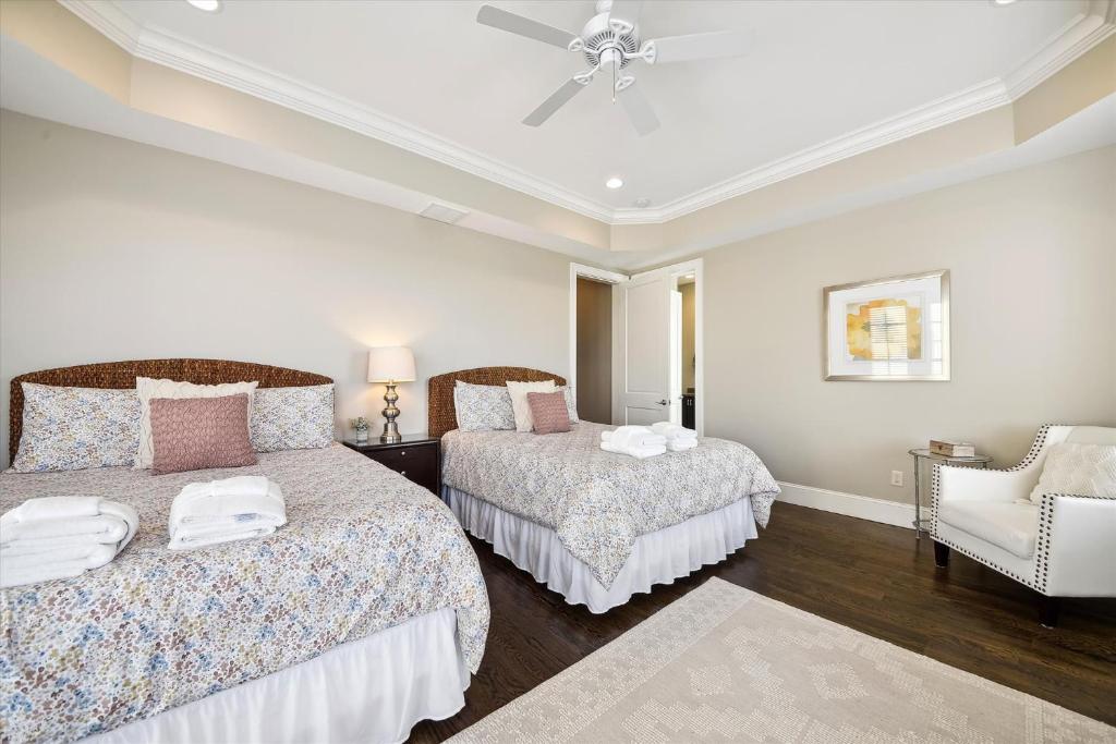 a bedroom with two beds and a ceiling fan at 27 Singleton Beach- Oceanfront, Private Pool, Pool Table, FREE Activities Included in Hilton Head Island