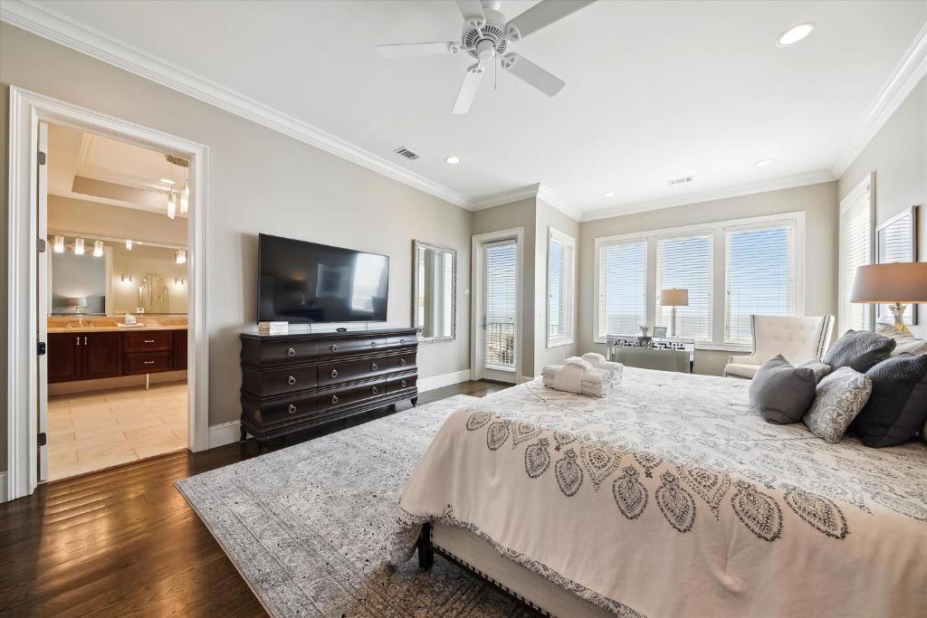 a bedroom with a large bed and a flat screen tv at 27 Singleton Beach- Oceanfront, Private Pool, Pool Table, FREE Activities Included in Hilton Head Island