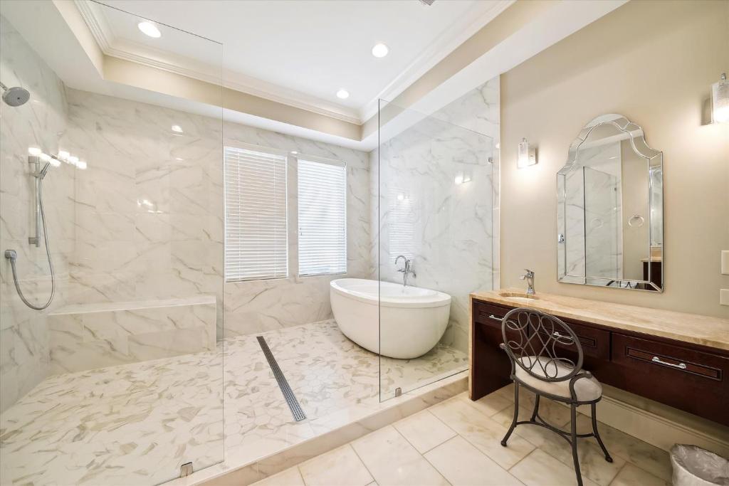 a bathroom with a tub and a shower and a sink at 27 Singleton Beach- Oceanfront, Private Pool, Pool Table, FREE Activities Included in Hilton Head Island