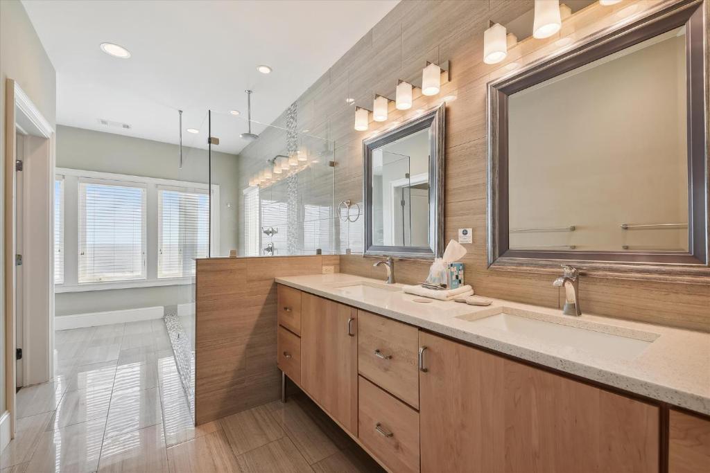 a bathroom with a sink and a large mirror at 27 Singleton Beach- Oceanfront, Private Pool, Pool Table, FREE Activities Included in Hilton Head Island
