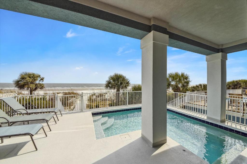 a view of the pool and beach from the balcony of a resort at 27 Singleton Beach- Oceanfront, Private Pool, Pool Table, FREE Activities Included in Hilton Head Island