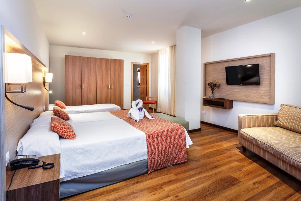Łóżko lub łóżka w pokoju w obiekcie Hotel Marquesa