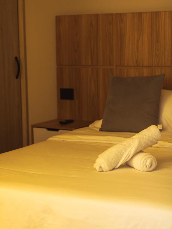 Una cama o camas en una habitación de Casa Origo Hospedaje