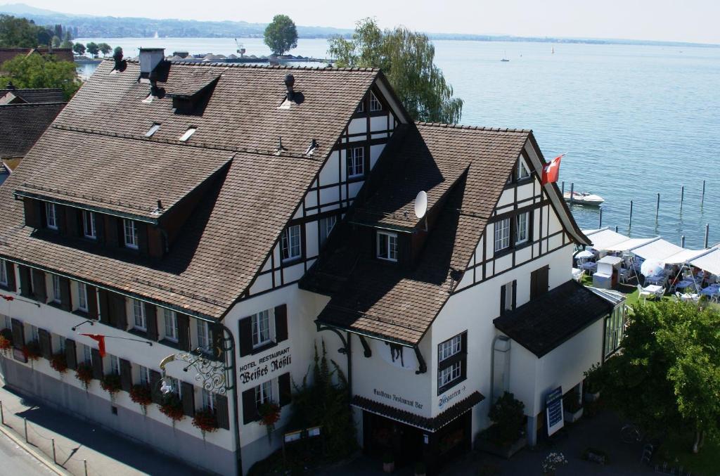 an aerial view of a building next to the water at Bodenseehotel Weisses Rössli in Staad