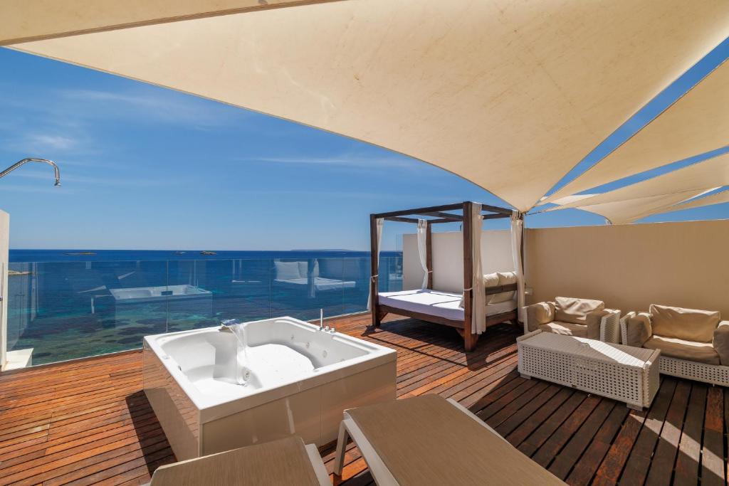 a hot tub on a deck with a view at Hotel Torre del Mar - Ibiza in Playa d'en Bossa