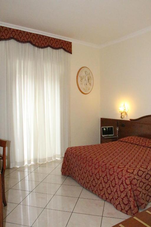 Postel nebo postele na pokoji v ubytování Hotel Mirage