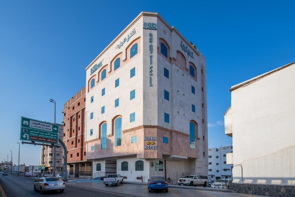 a building on the corner of a city street at Al Ayniah Hotel in Medina