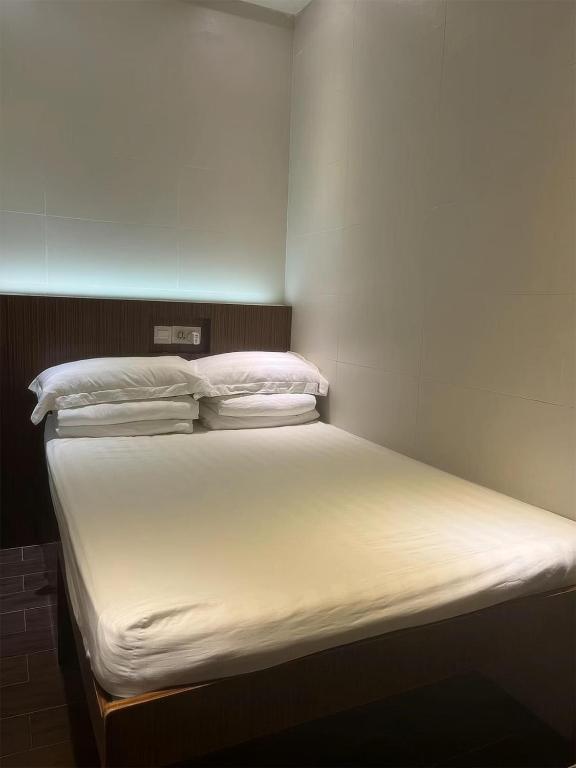 Voodi või voodid majutusasutuse 香港金門賓館 KamMun Guest House toas