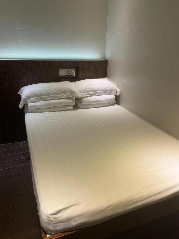 Voodi või voodid majutusasutuse 香港金門賓館 KamMun Guest House toas
