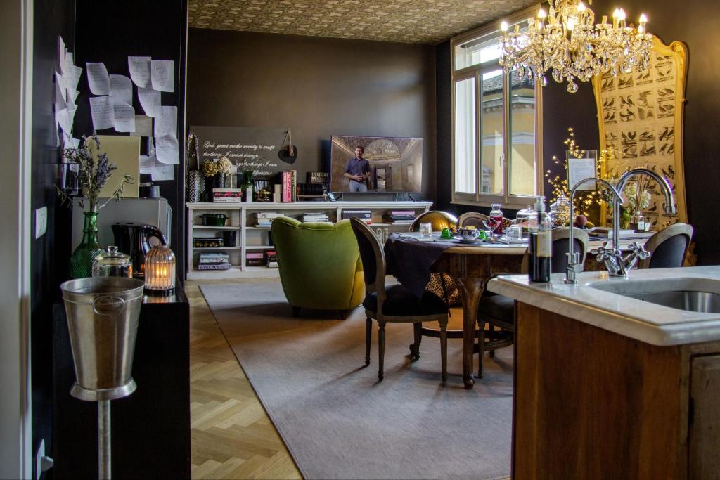 a kitchen and dining room with a table and a sink at La Maison du Théâtre in Ravenna