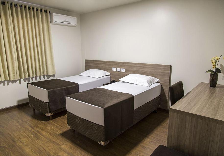 Postel nebo postele na pokoji v ubytování Arca's Hotel Umuarama