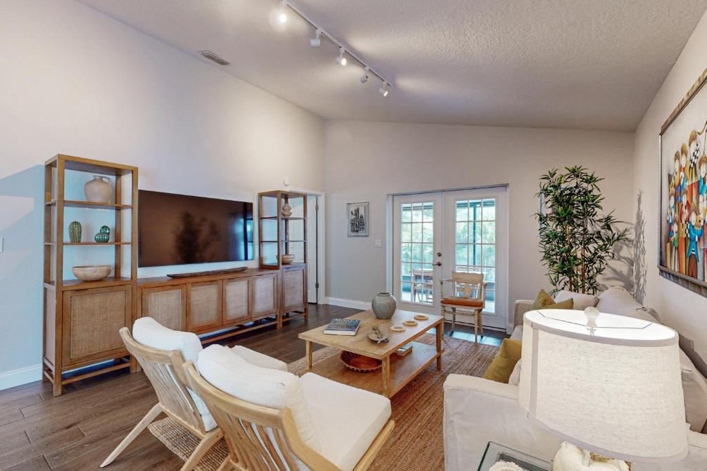 a living room with a couch and a tv at Bayside Bungalow in Tampa