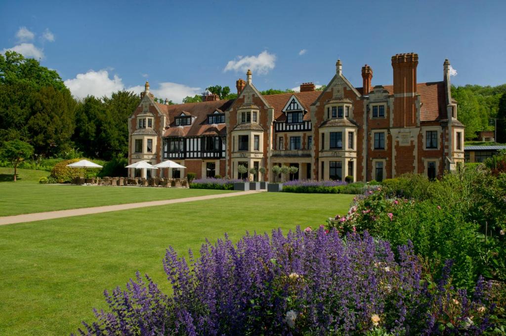 a large house with a lawn and purple flowers at The Wood Norton in Evesham