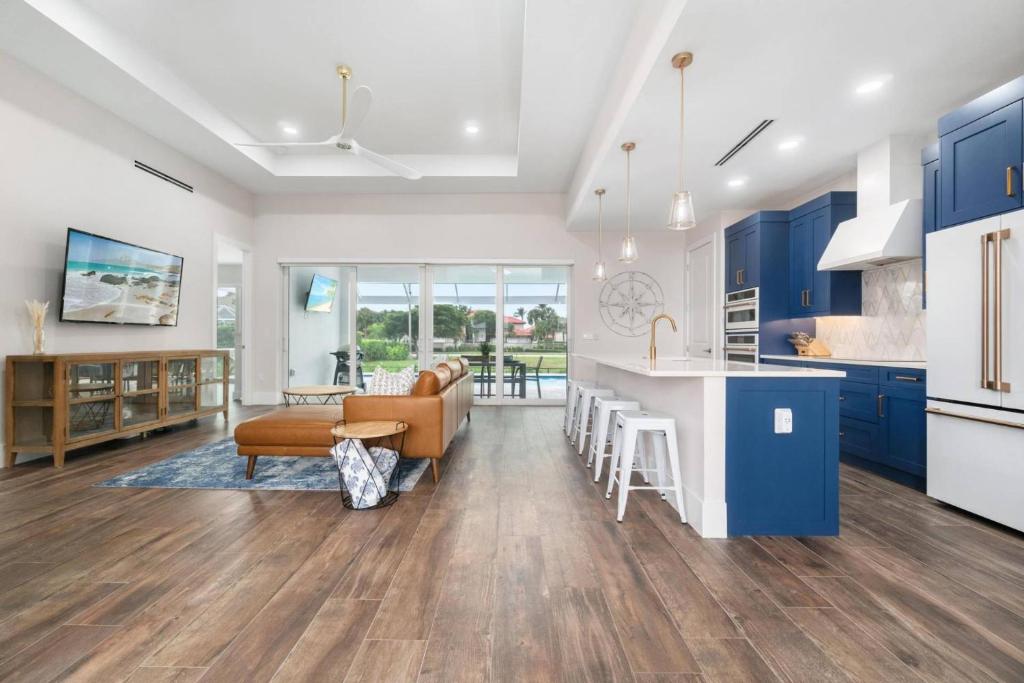 a kitchen and living room with blue cabinets at Deja Blu in Marco Island