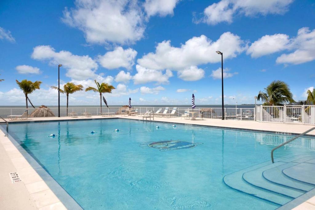 a large swimming pool with the ocean in the background at Best Catch on Grouper LN at Ocean Isles in Marathon