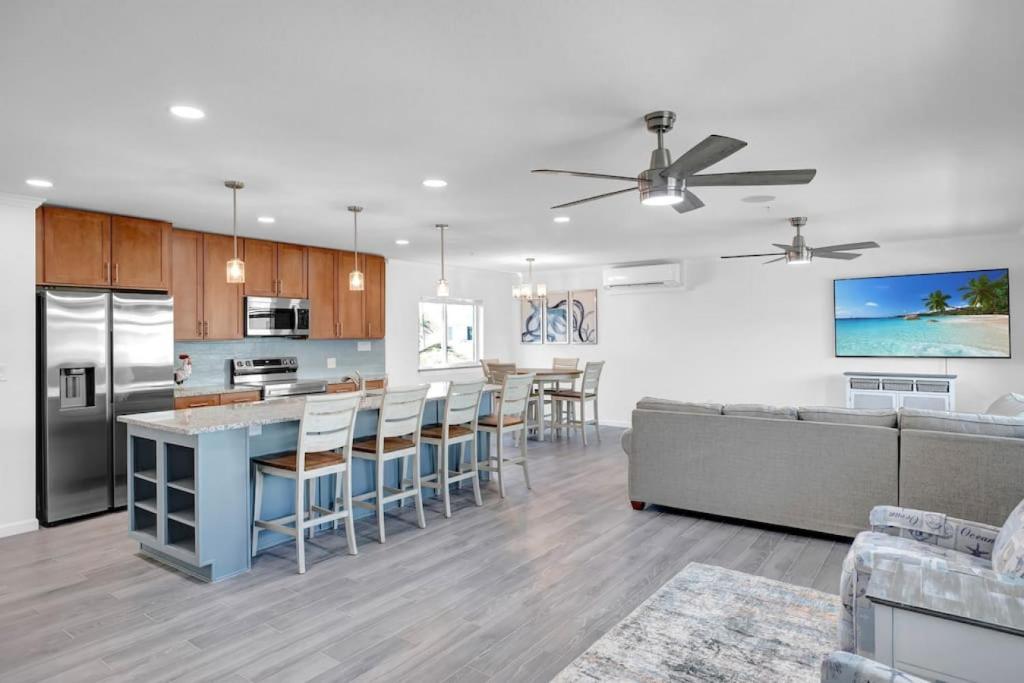 a kitchen and living room with a couch and a table at Blue Octopus Hideaway at OI in Marathon