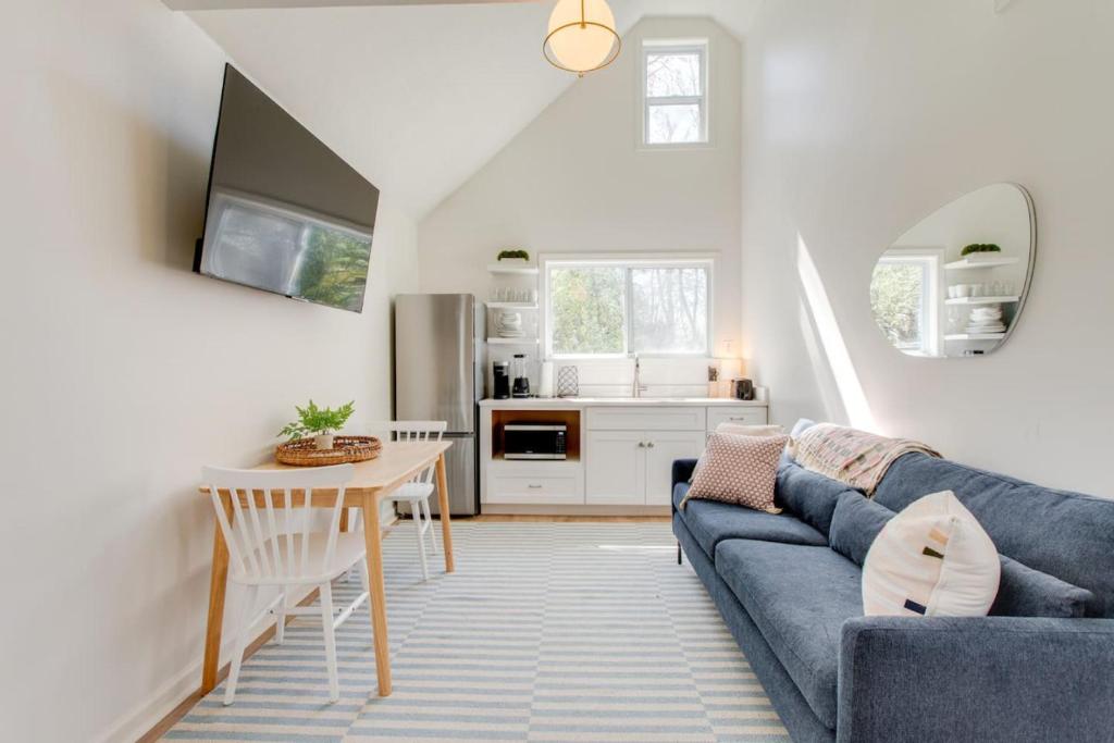 a living room with a blue couch and a table at Sweet Tea Cottage 1BR and Loft in Murfreesboro