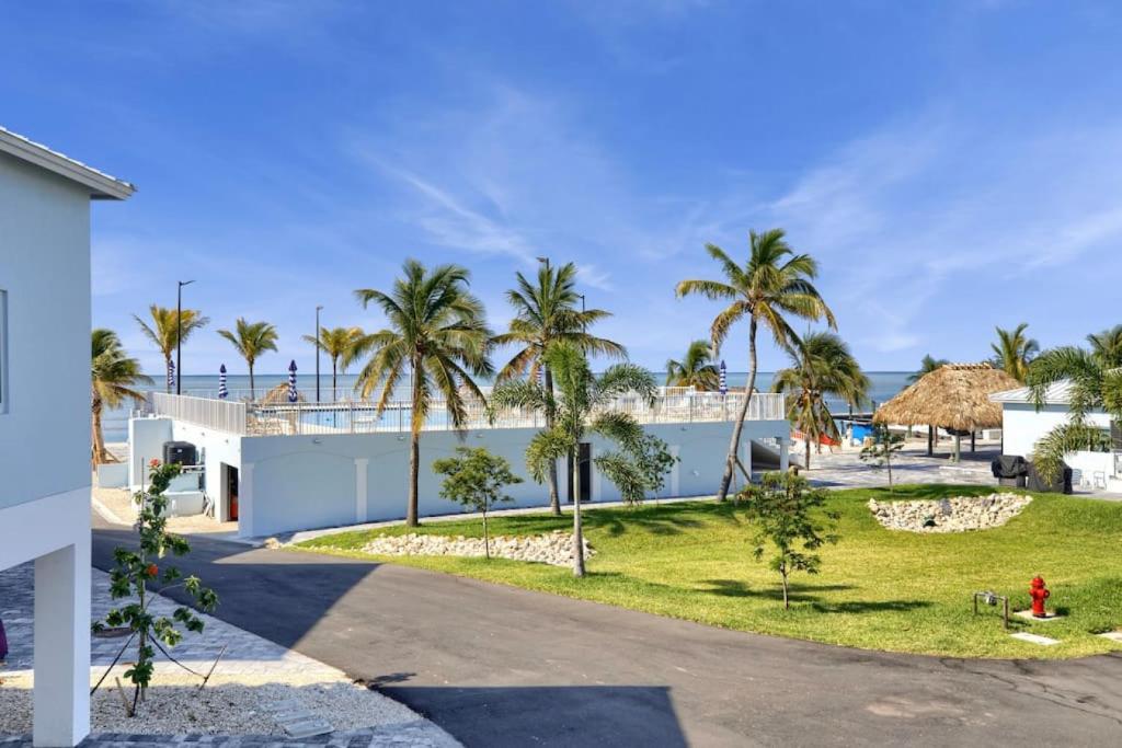 a view of the beach from the driveway of a house at Ocean Front Breeze in Paradise in Marathon