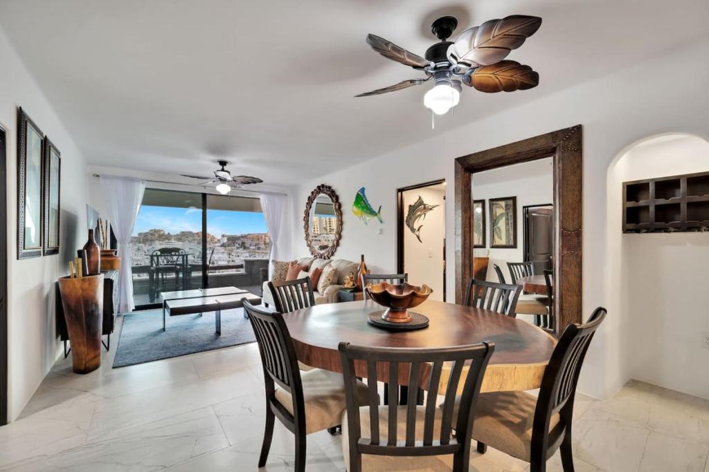 a dining room and living room with a table and chairs at Completely Remodeled 2BD-2BA Plaza Bonita in Cabo San Lucas