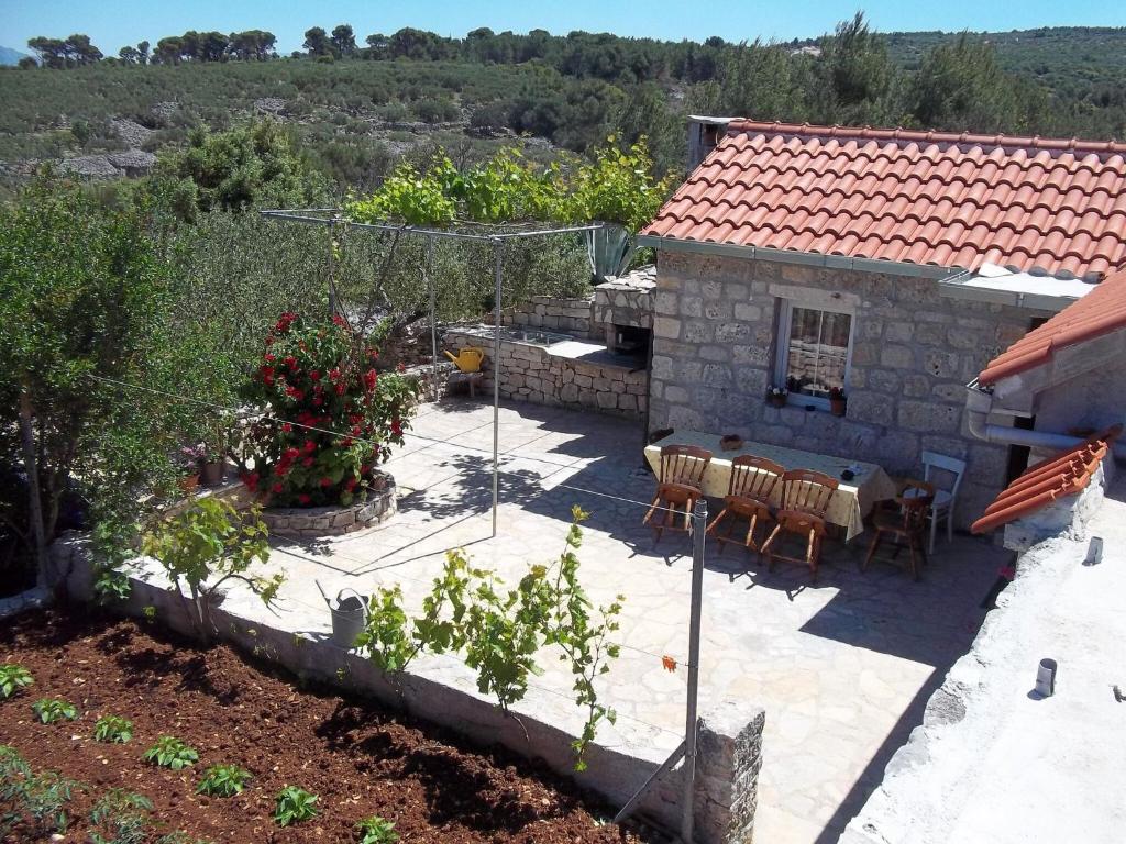 a patio with a table and chairs and a house at Holiday Home in Mirca with terrace in Mirce