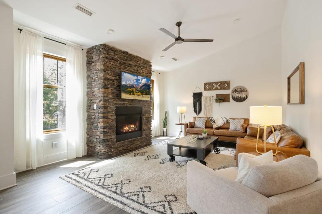 a living room with a couch and a fireplace at Evergreen On Main in Blowing Rock