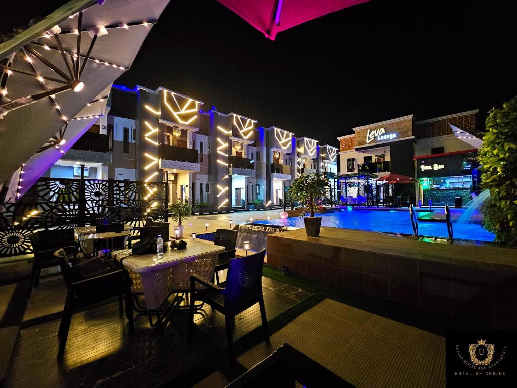 a hotel with a swimming pool at night at 2 Bed Apartment 6 - Chic Benin City Hideaway in Benin City