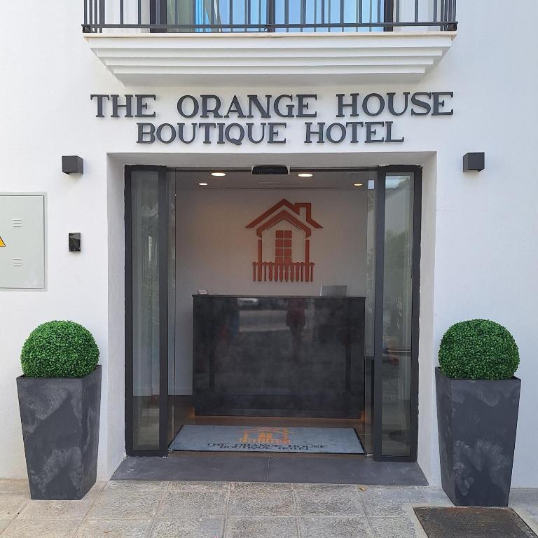 an entrance to a orange house boutique hotel at The Orange House Boutique Hotel and Upstairs Rooftop Bar Center of La Cala de Mijas 100m from the Beach in La Cala de Mijas