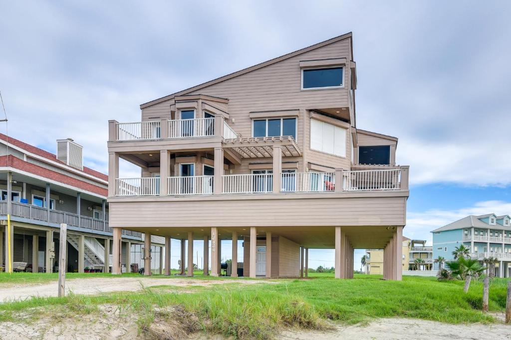 an apartment building with balconies on the beach at Oceanfront Galveston Beach House Steps to Sand! in Galveston