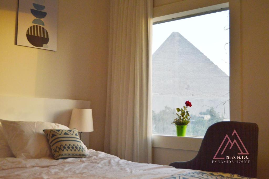 Postel nebo postele na pokoji v ubytování Maria Pyramids House