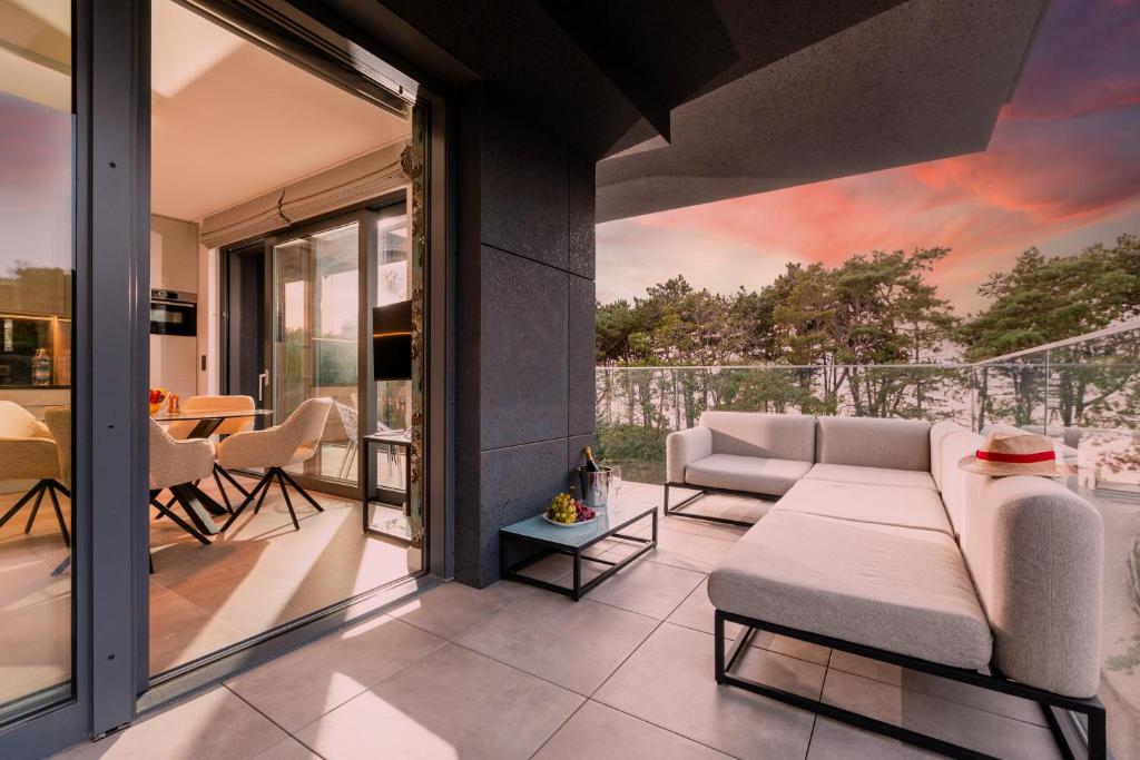 a living room with a couch and a table at HEVENIA POGORZELICA - Apartament 4 z bezpośrednim widokiem na morze in Pogorzelica