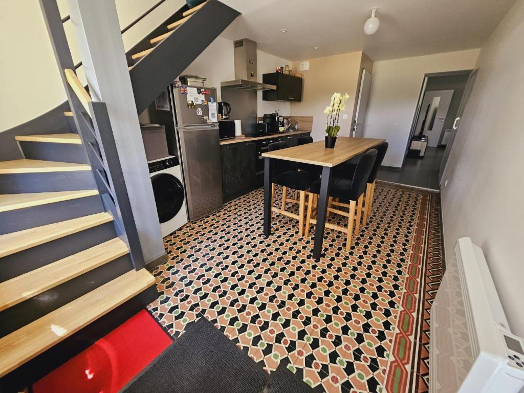 a small kitchen with a table and a staircase at Gîte de 2 chambres - Ancenis A11 - Logis du Château Rouge in Mésanger
