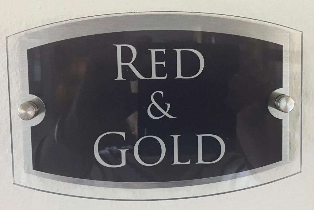 a sign with the words red and gold on it at Yr Hen Felin - The Old Mill B&B in Morfa Nefyn