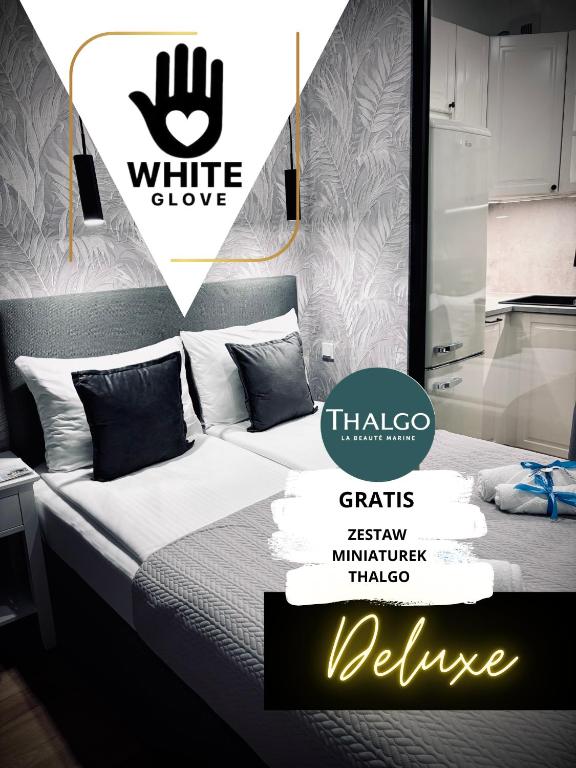 a bedroom with a bed with a sign that says white glove at Apartament WHITE GLOVE Deluxe Warmiński Port in Olsztyn
