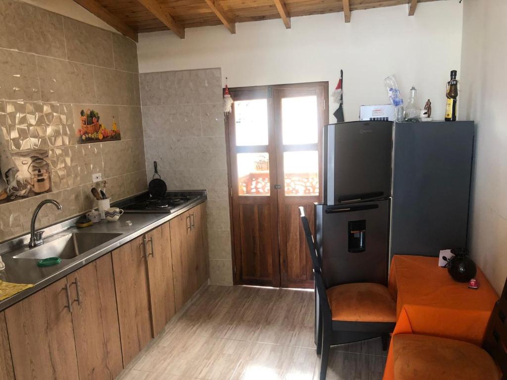 a kitchen with a sink and a refrigerator at habitacion amoblada in Sonsón