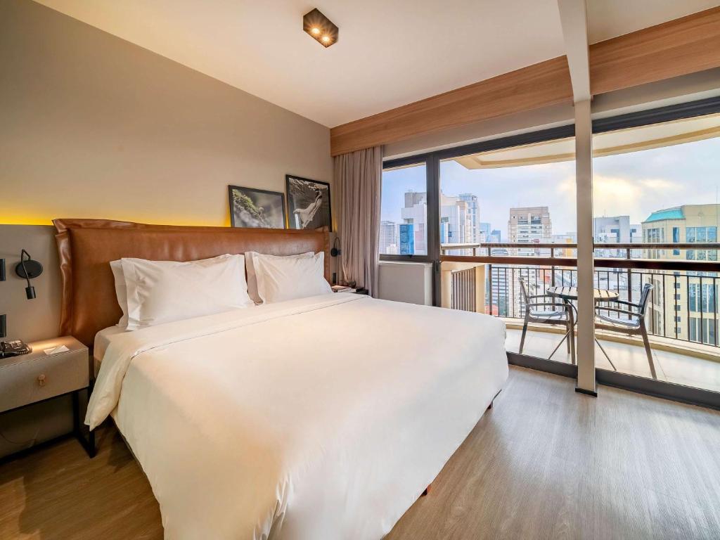Cama ou camas em um quarto em Grand Mercure SP Itaim Bibi