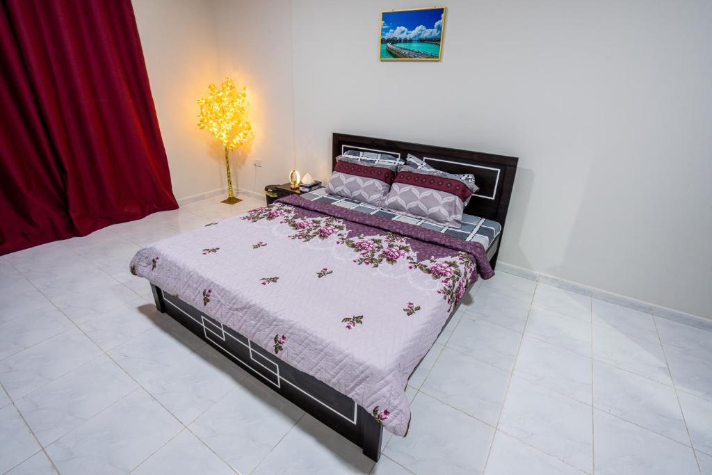 a bedroom with a large bed in a room at tourist Family and couple private Rooms ME11 BGR 01 baith al jannah LLC one private room in three bedroom apartment in Abu Dhabi