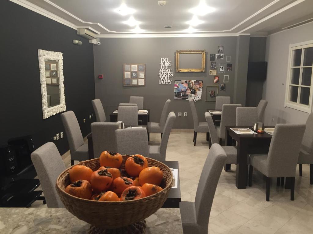 a dining room with a bowl of oranges on a table at Hotel 201 in Podgorica