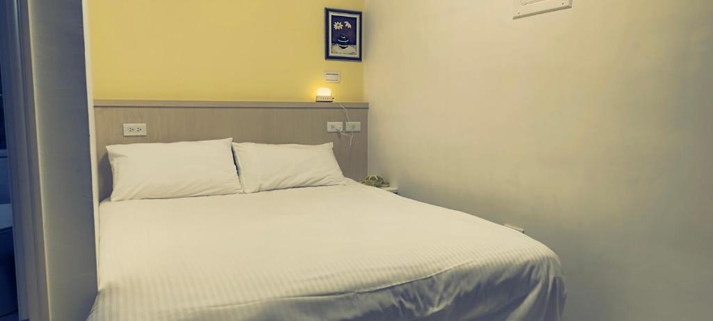 Postel nebo postele na pokoji v ubytování Zhuge Hospitality Homestay