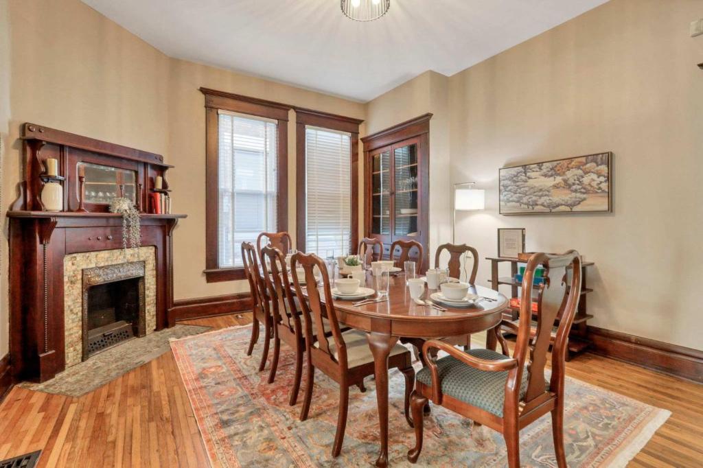 a dining room with a table and chairs and a fireplace at 4 Bed Duplex near Goodale Park in Columbus
