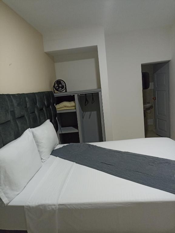 Postel nebo postele na pokoji v ubytování Hotel Empresarial