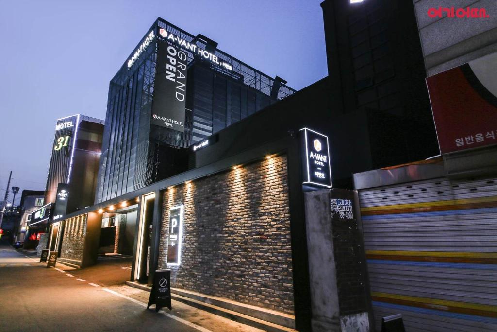 a building with signs on the side of a street at Hotel Avant in Cheonan