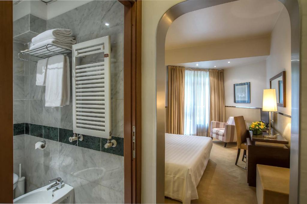 Postel nebo postele na pokoji v ubytování Mini Palace Hotel