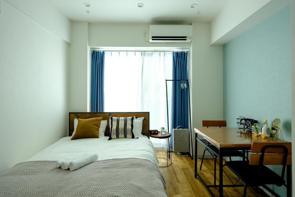 Postel nebo postele na pokoji v ubytování 東京新橋579 Shinbashi Residence