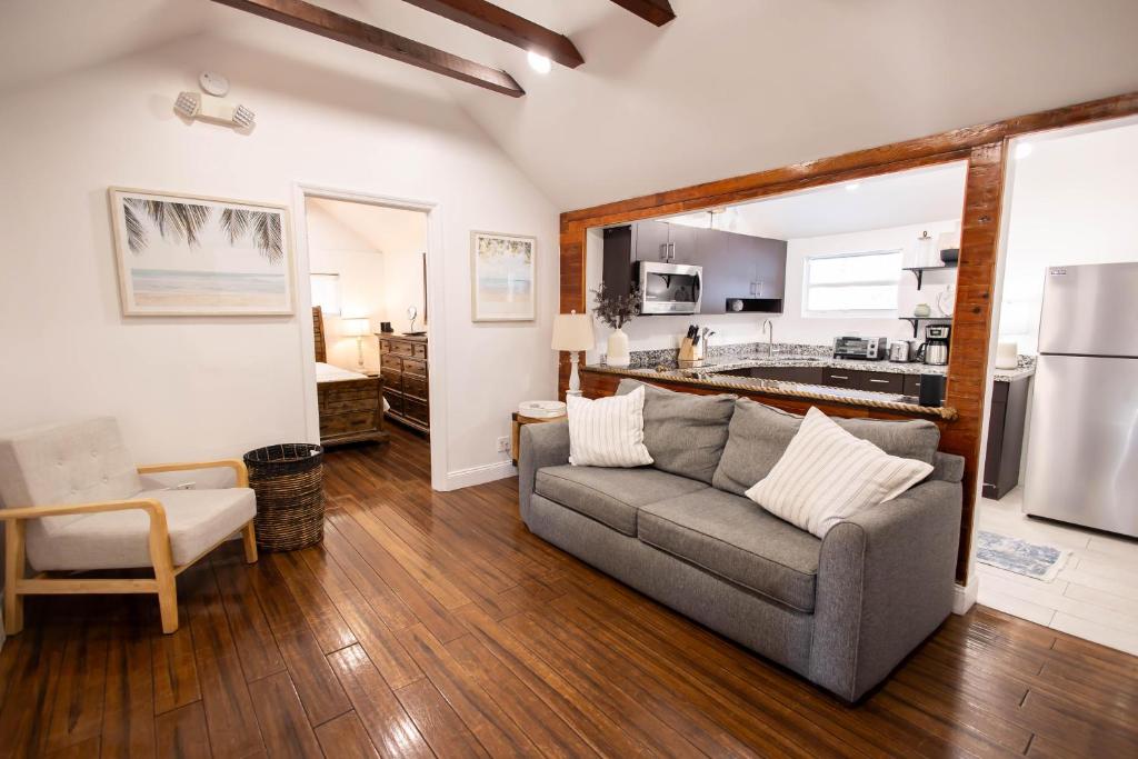 a living room with a couch and a kitchen at The Caroline Suite in Key West