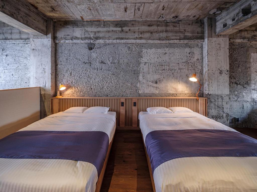 Postel nebo postele na pokoji v ubytování Arcade Hotel
