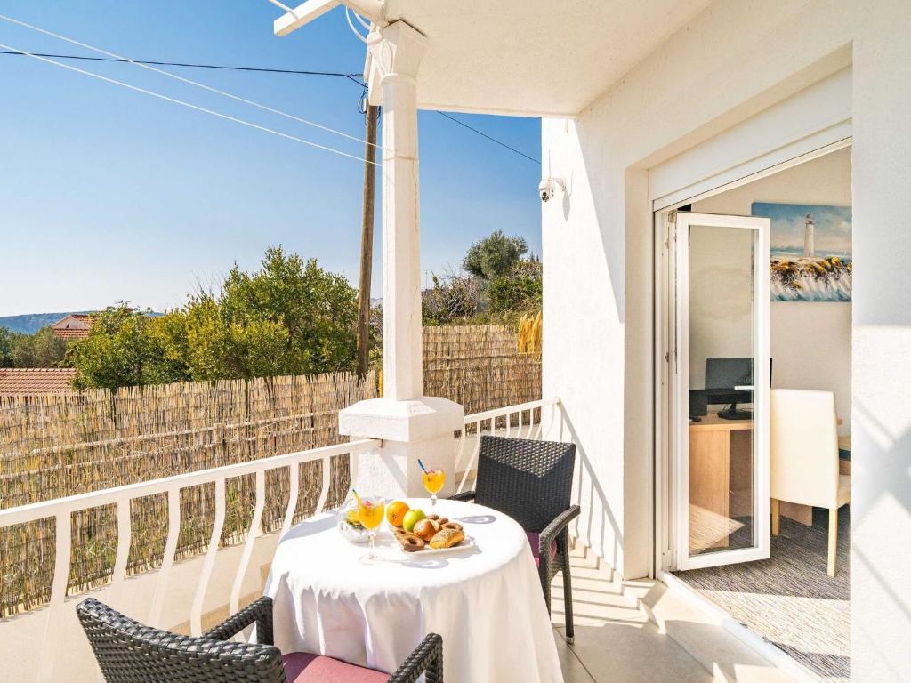 a table with a bowl of fruit on a balcony at Apartments Bla evi - Comfort Two Bedroom Apt with Hot Tub and Sea View in Mlini