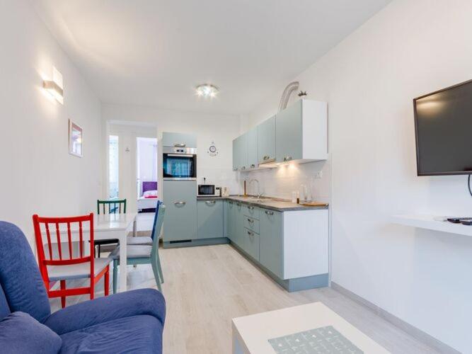 a kitchen and a living room with a couch and a table at Apartment Karlo - Two Bedroom Apartment with Balcony Matani in Kaštela